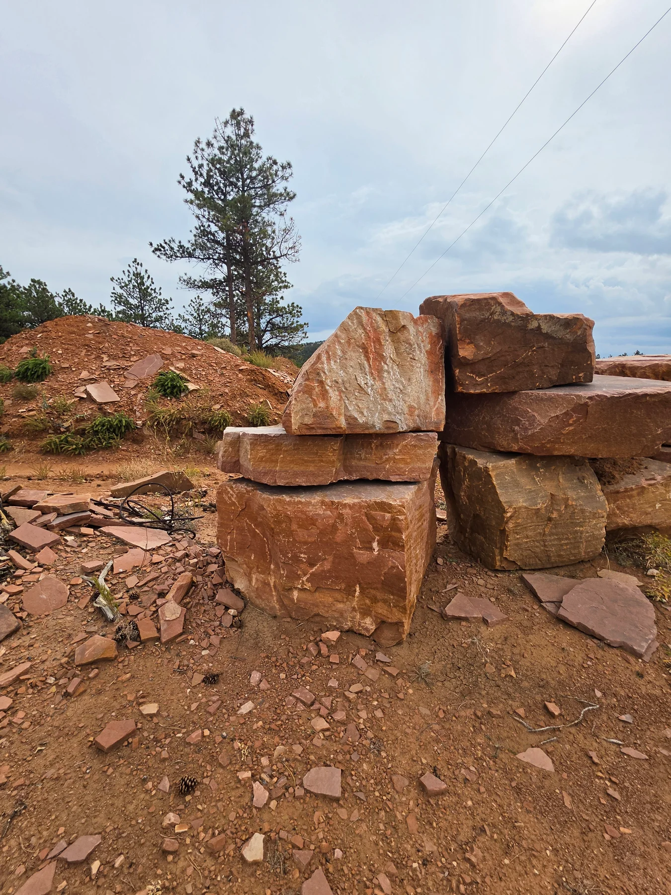Large natural sandstone boulders and blocks stacked at the Lyons quarry