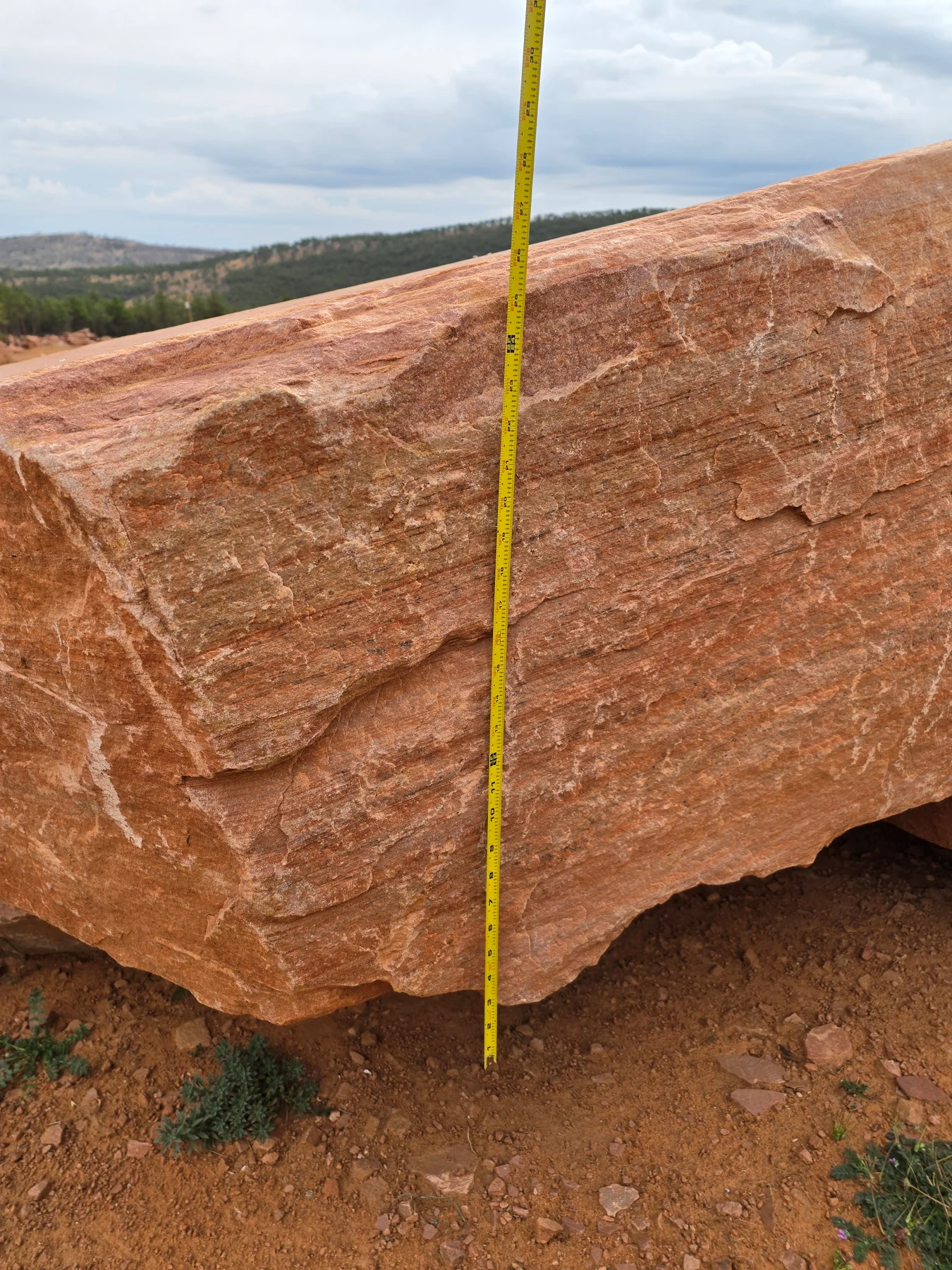 Tape measure showing the thickness of a sandstone block